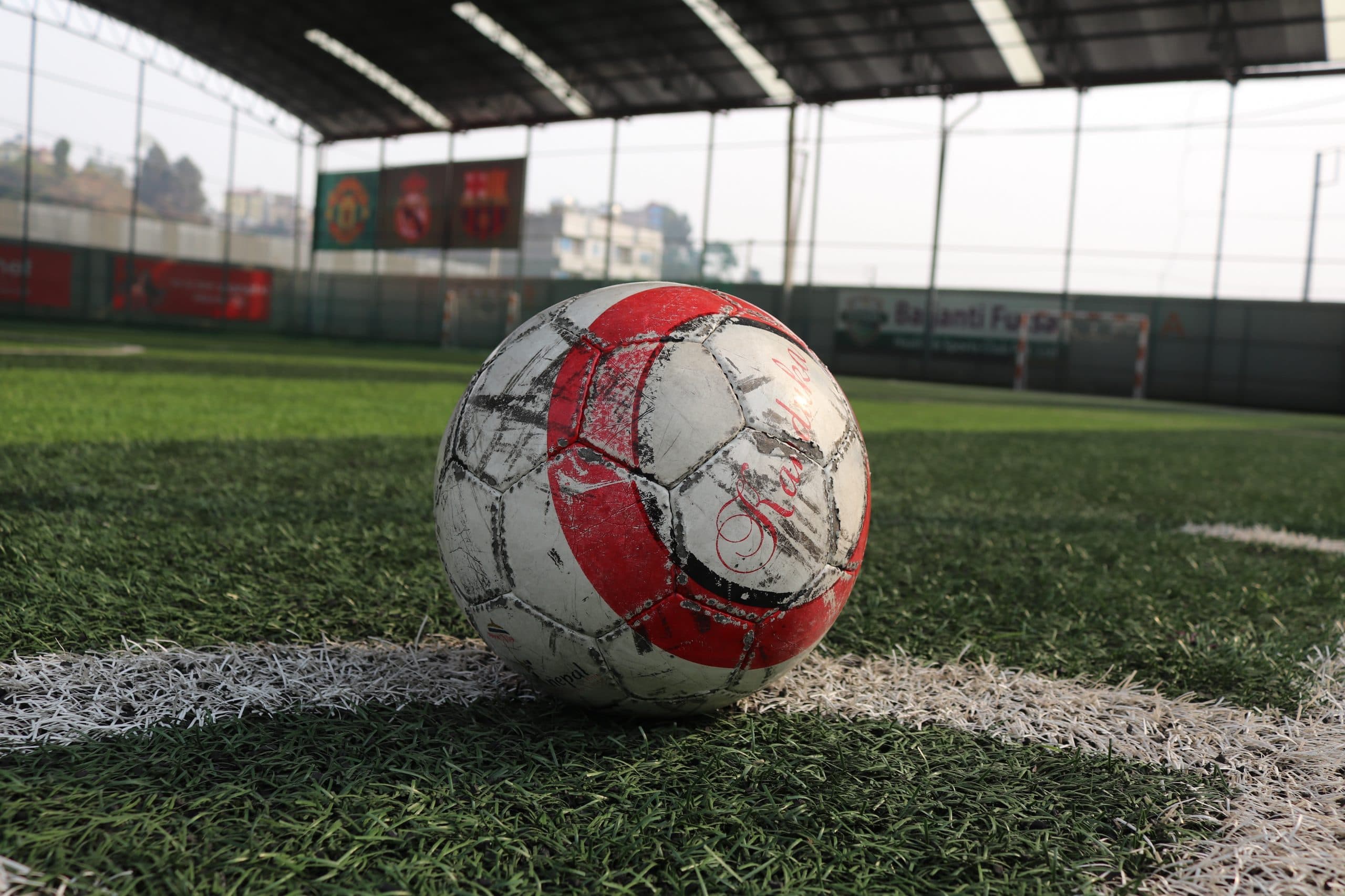 A futsal ball resting on the court